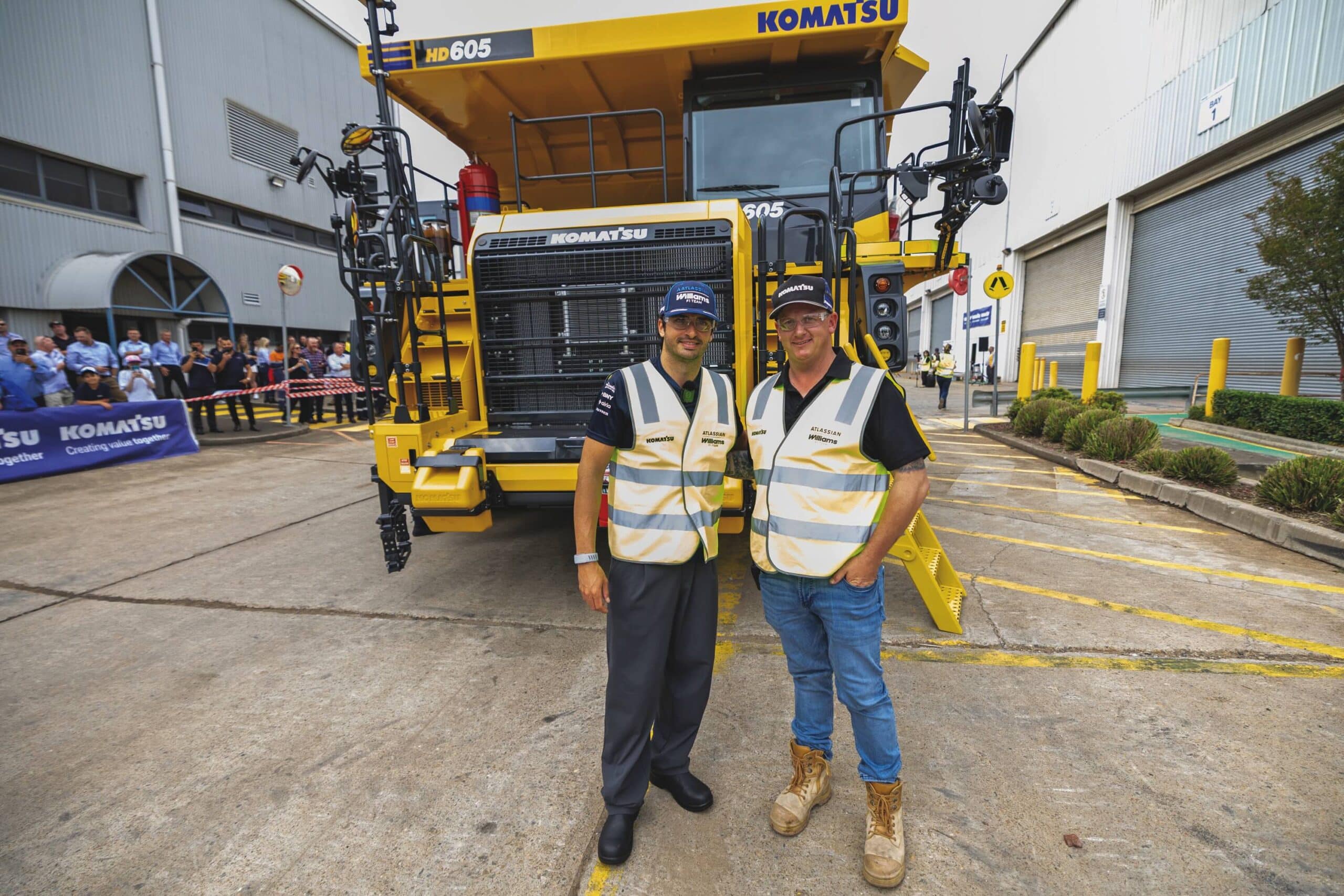 Carlos Sainz and Komatsu Australia employee Nathan Froome next to Komatsu’s HD605 rigid dump truck.